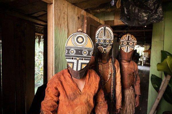 Three young boys wear their traditional Miraña tribe costume.